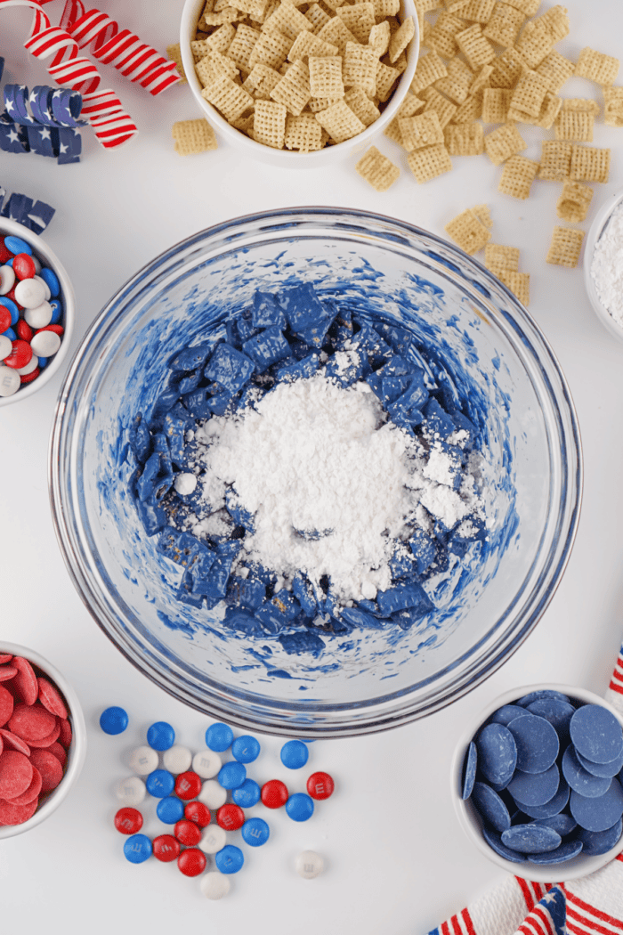 adding powdered sugar to the coated cereal