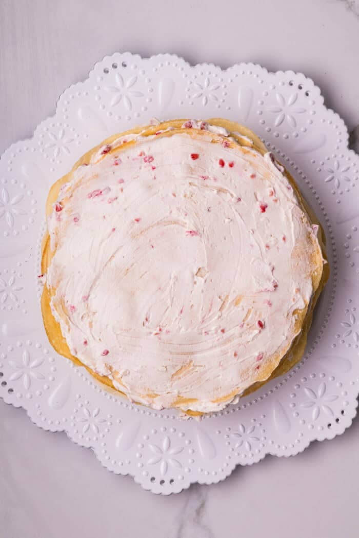 Raspberry cream filling on top of a crepe mille cake