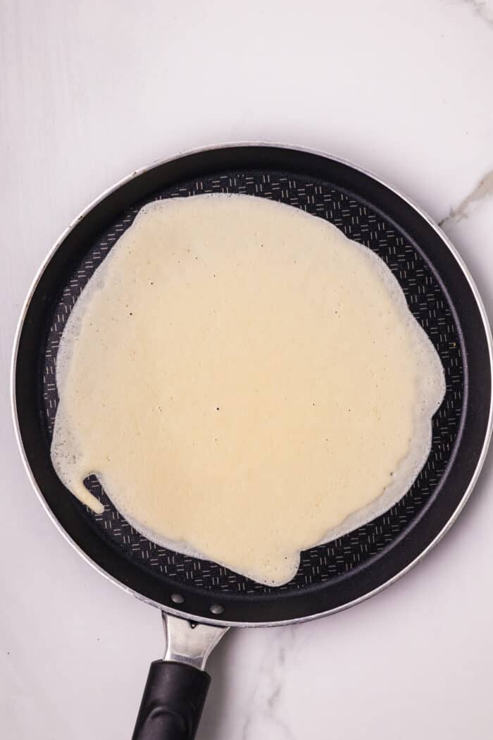 Crepe batter on a frying pan