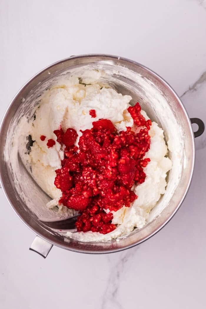 Raspberries being folded into cream filling