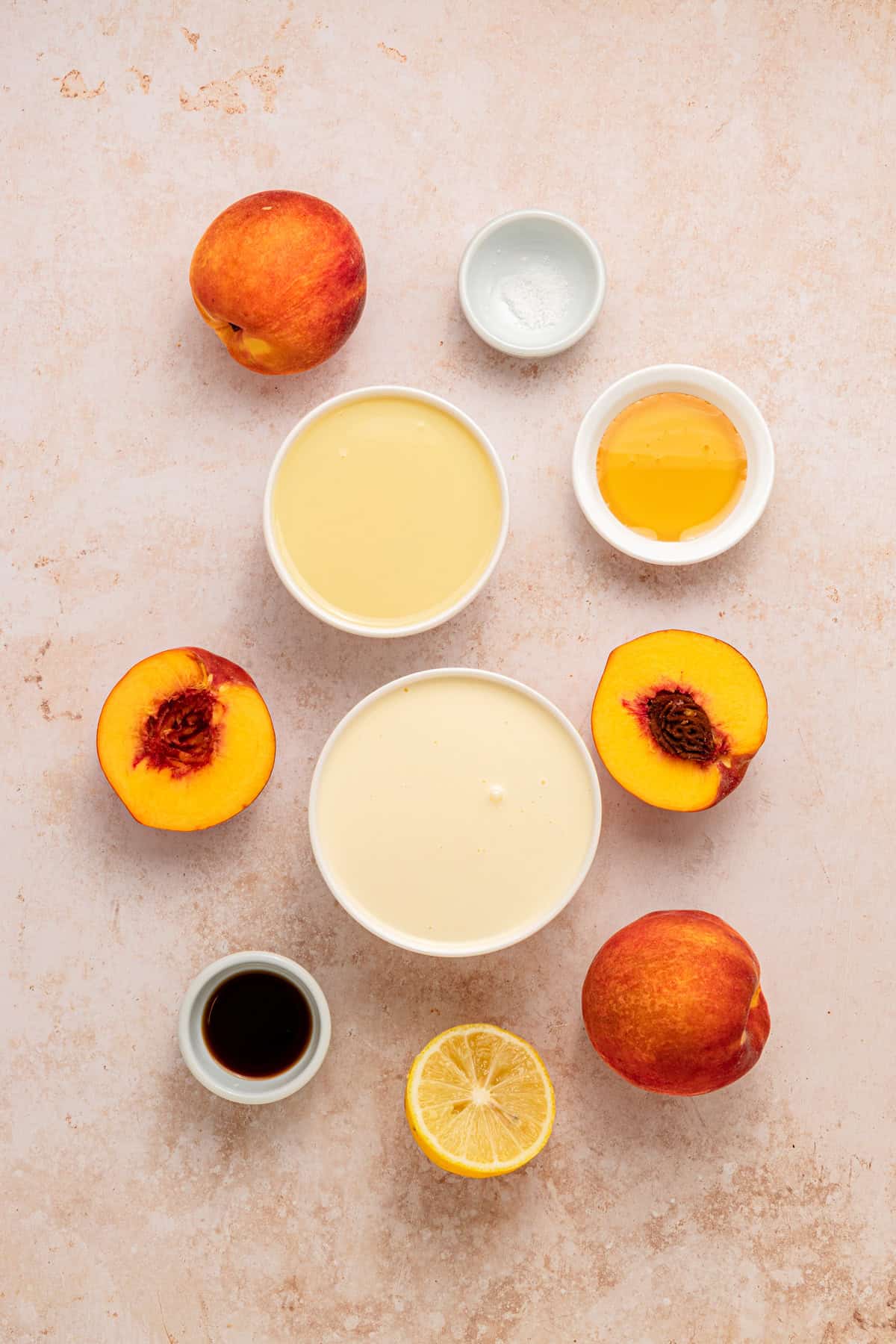 Fresh peaches are turned into a compote and swirled into a mixture of sweetened condensed milk & heavy cream in this No-Churn Peach Ice Cream. Overhead view of ingredients needed to make peach ice cream