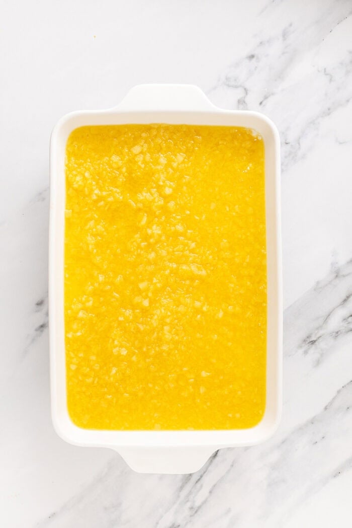 A salty pretzel crust, tangy cream cheese filling, and tart pineapple combine to make this Pineapple Pretzel Salad. The pineapple jello layer spread on top of the cream cheese layer