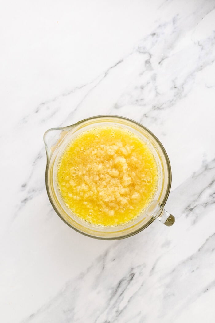 A salty pretzel crust, tangy cream cheese filling, and tart pineapple combine to make this Pineapple Pretzel Salad. Crushed pineapple and jello in a bowl