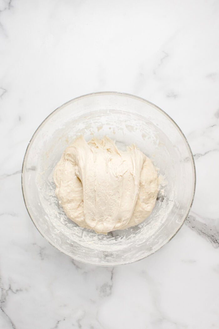 Made with an active sourdough starter, pantry staples, and a simple process, this Sourdough Bread recipe is perfect for beginners. Sourdough bread dough stretched across the top.