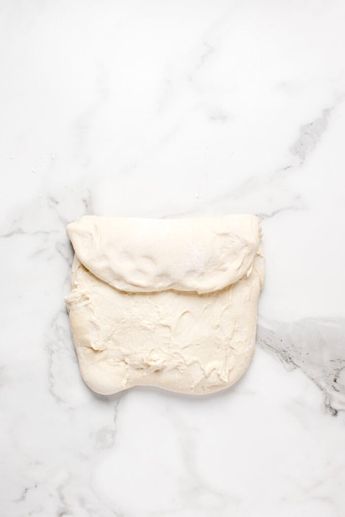 Made with an active sourdough starter, pantry staples, and a simple process, this Sourdough Bread recipe is perfect for beginners. A third of the dough folded over