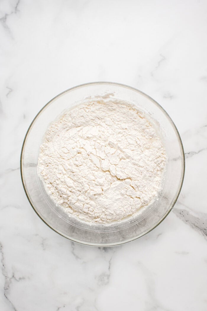 Made with an active sourdough starter, pantry staples, and a simple process, this Sourdough Bread recipe is perfect for beginners. Flour added to the bowl