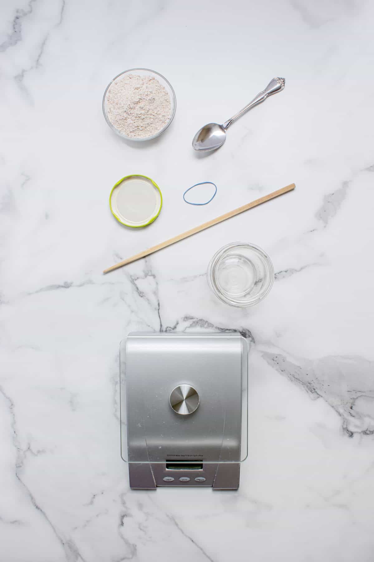 This easy sourdough starter recipe walks you through the process day-by-day with images. Great for beginners! Overhead view of tools and ingredients needed to make a sourdough starter