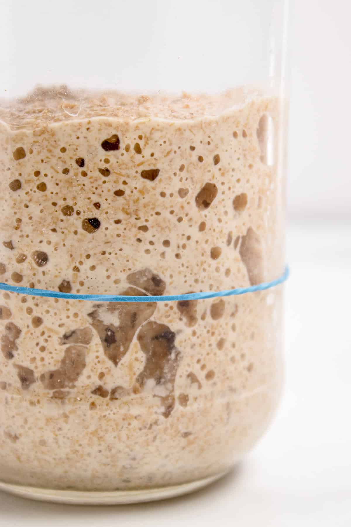 Close up of a jar of sourdough starter that has doubled in size