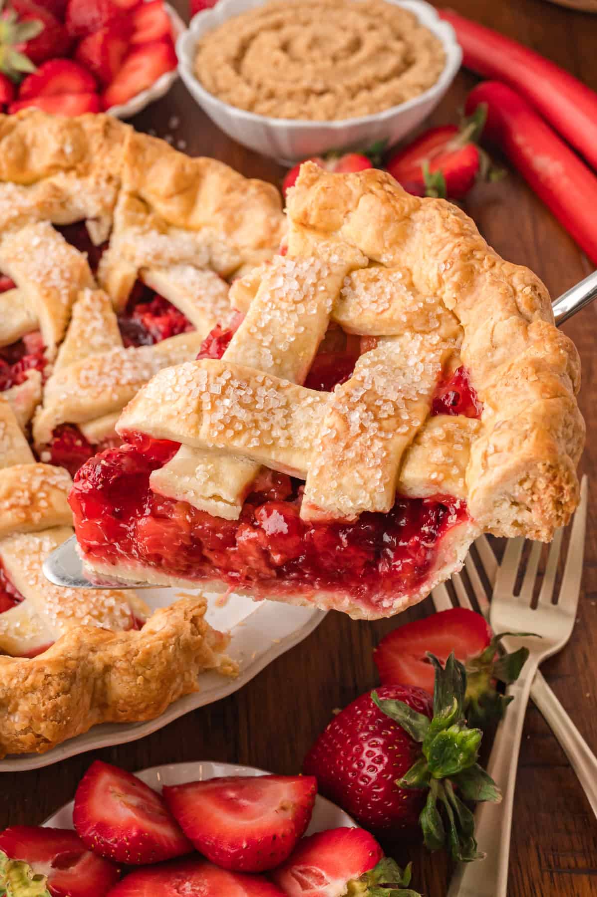 Lifting a slice of strawberry rhubarb pie from the pan