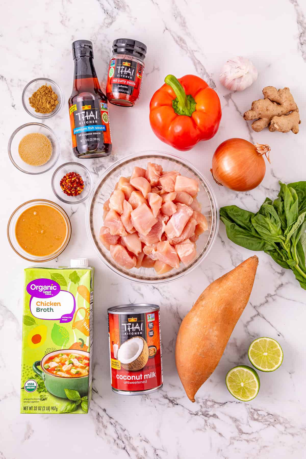 Chicken, sweet potatoes, coconut milk, curry paste, and peanut butter are slow-cooked to make this easy Thai Red Curry Chicken. Overhead view of ingredients needed to make crockpot Thai red curry chicken