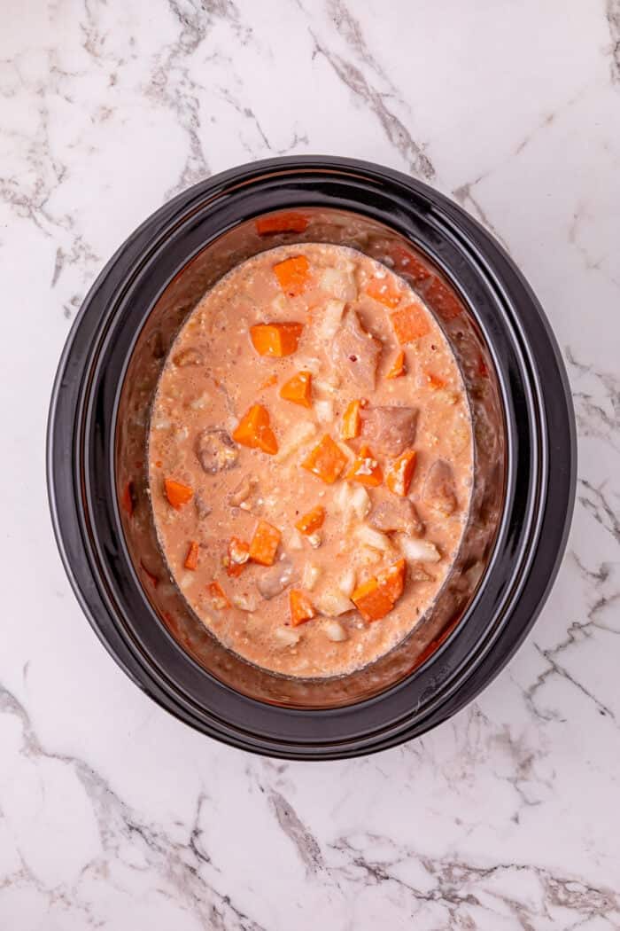 Chicken, sweet potatoes, coconut milk, curry paste, and peanut butter are slow-cooked to make this easy Thai Red Curry Chicken. Broth, peanut butter, and coconut milk poured over the mixture