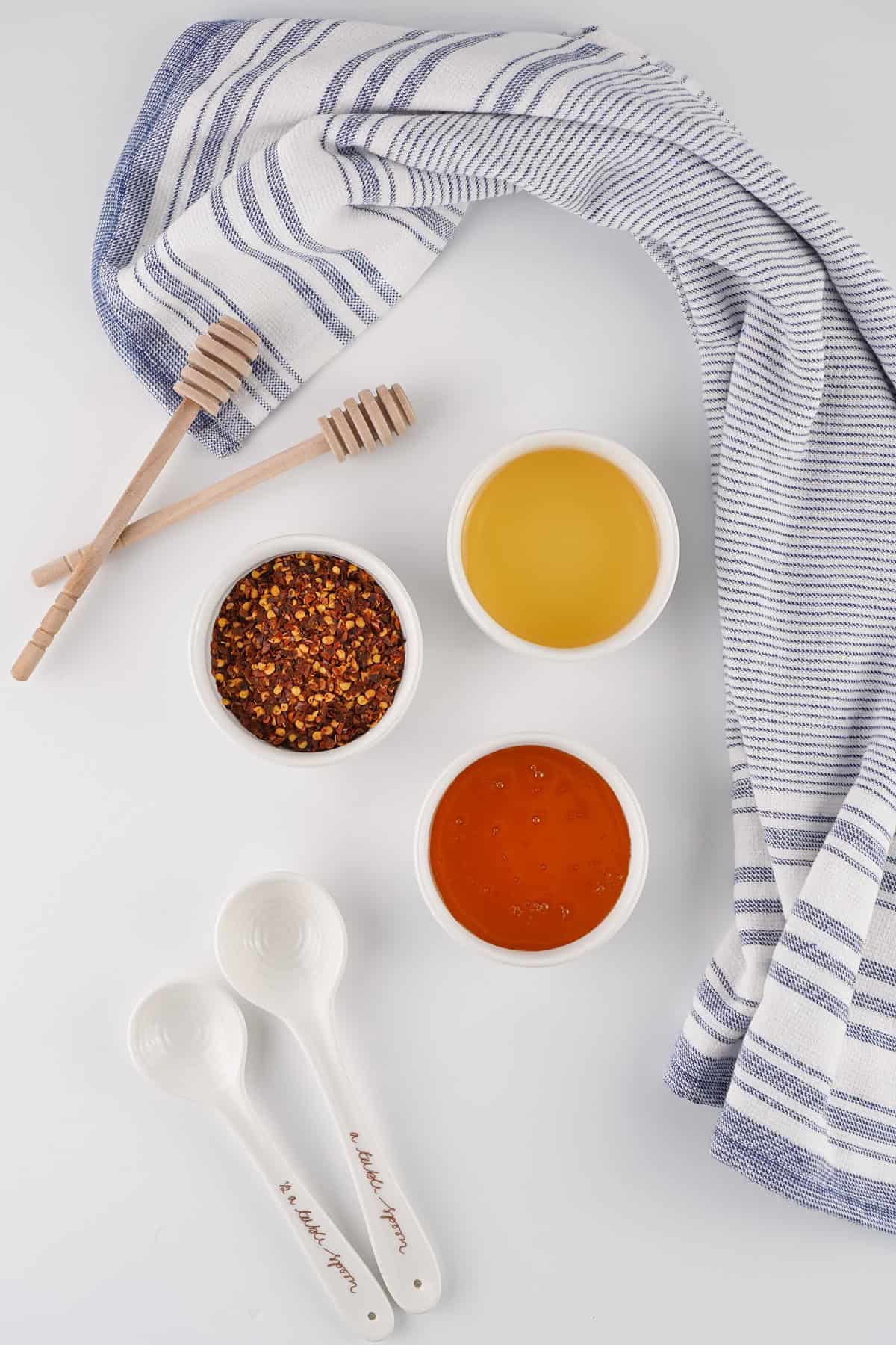 This Hot Honey recipe is made with just 3 ingredients in 7 minutes. It’s ridiculously easy and so much cheaper than buying it at the store. Overhead view of ingredients needed to make homemade hot honey