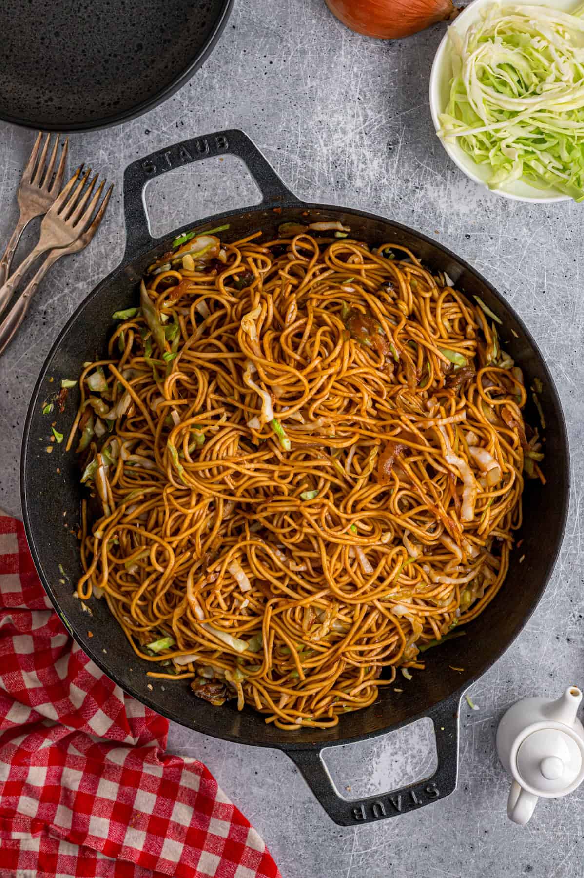 With tender noodles coated in a savory sauce and crunchy veggies, this copycat Panda Express Chow Mein tastes even better than takeout. Overhead view of a skillet of Panda Express chow mein