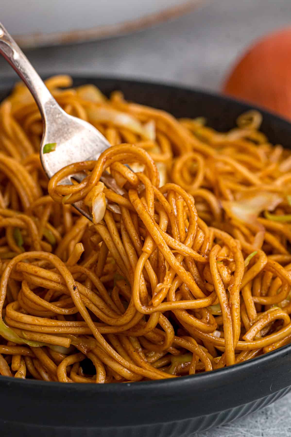 With tender noodles coated in a savory sauce and crunchy veggies, this copycat Panda Express Chow Mein tastes even better than takeout. A fork in a bowl of copycat Panda Express chow mein