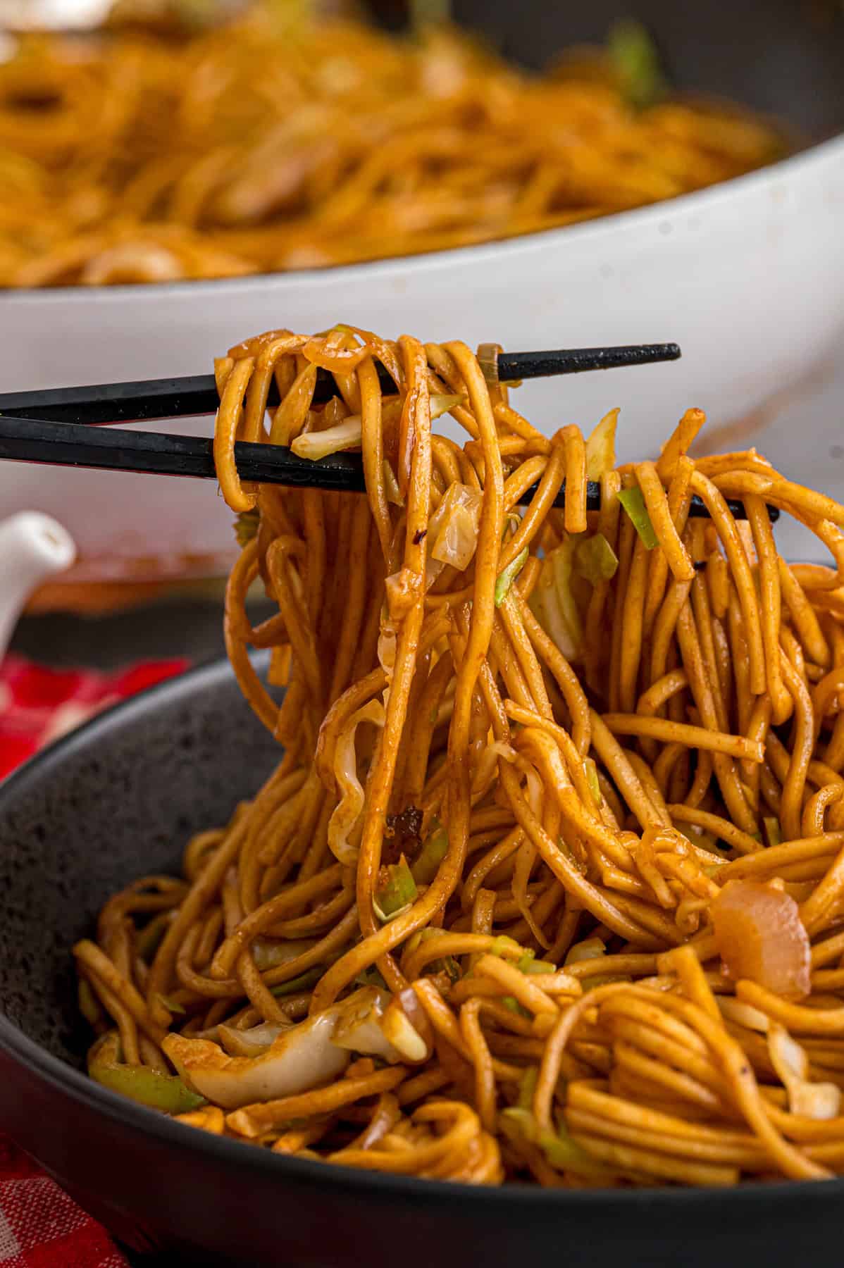 With tender noodles coated in a savory sauce and crunchy veggies, this copycat Panda Express Chow Mein tastes even better than takeout. Chopsticks lifting copycat Panda Express chow mein