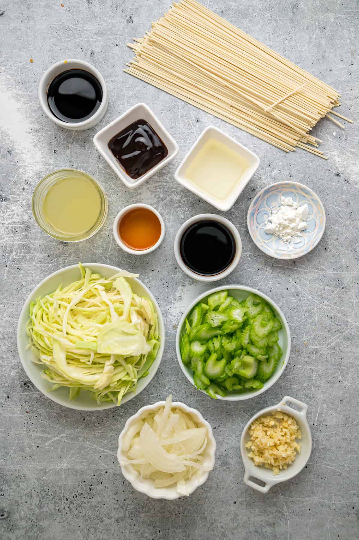 With tender noodles coated in a savory sauce and crunchy veggies, this copycat Panda Express Chow Mein tastes even better than takeout. Overhead view of ingredients needed to make Panda Express chow mein