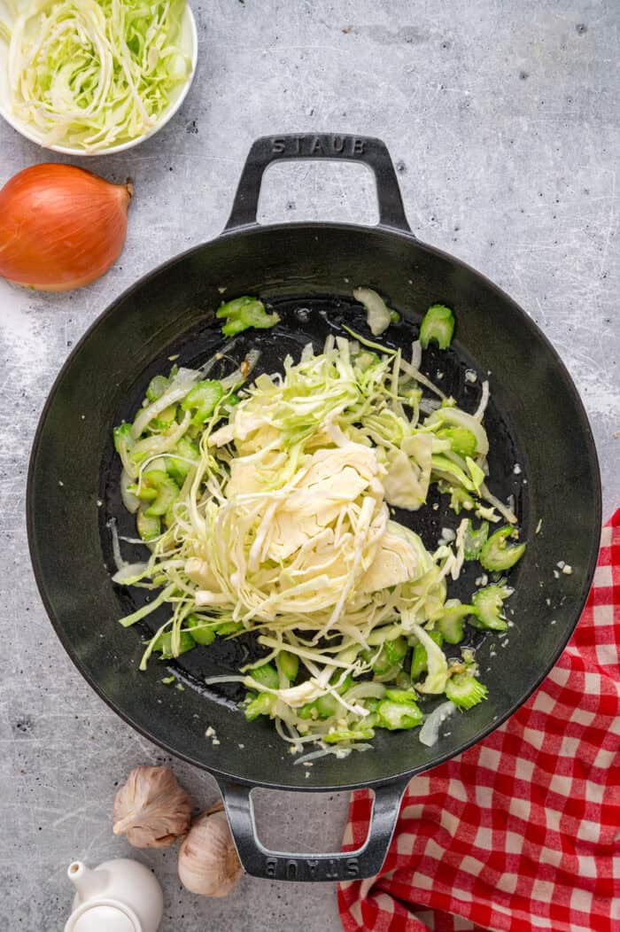With tender noodles coated in a savory sauce and crunchy veggies, this copycat Panda Express Chow Mein tastes even better than takeout. Sliced cabbage added to a skillet with onion