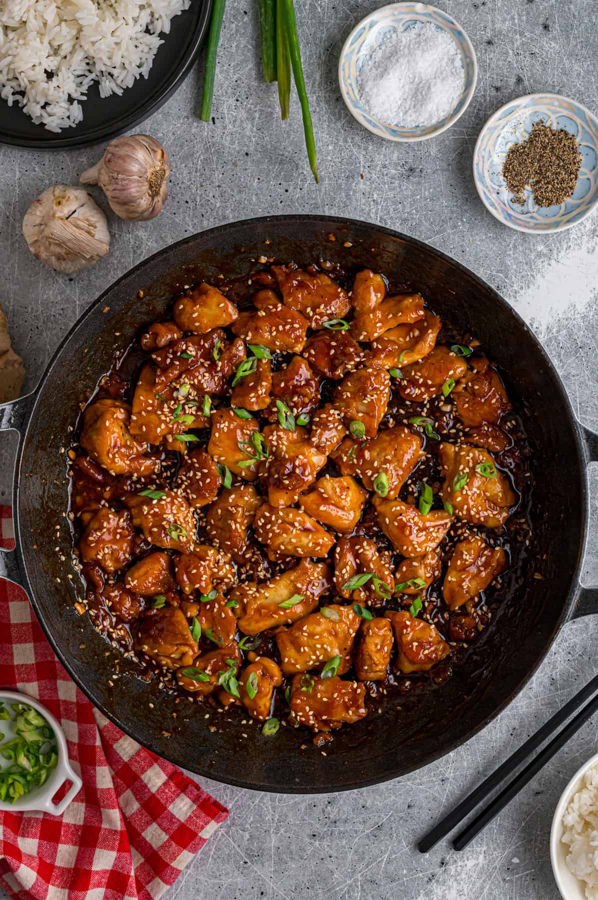 Ready in just 30 minutes, this Sesame Chicken recipe features tender, juicy pieces of chicken coated in a savory-sweet and nutty sauce. Overhead view of a skillet of sesame chicken