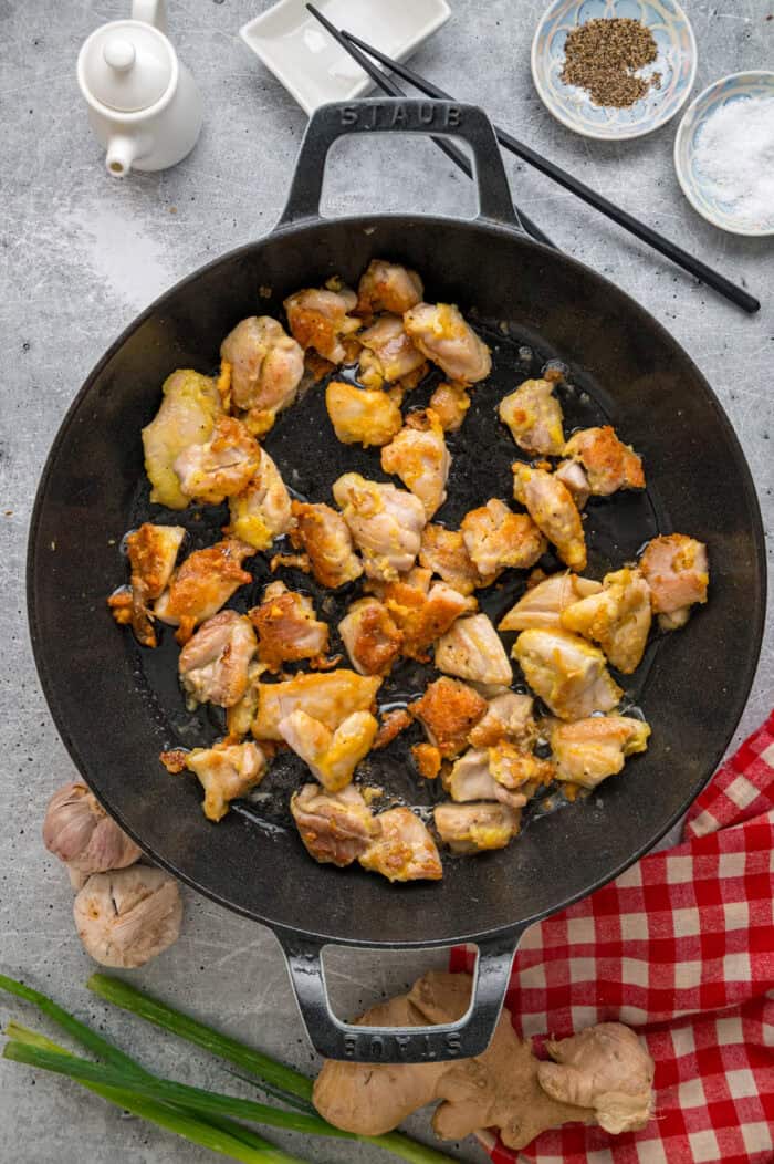 Ready in just 30 minutes, this Sesame Chicken recipe features tender, juicy pieces of chicken coated in a savory-sweet and nutty sauce. Pieces of chicken browning in a skillet