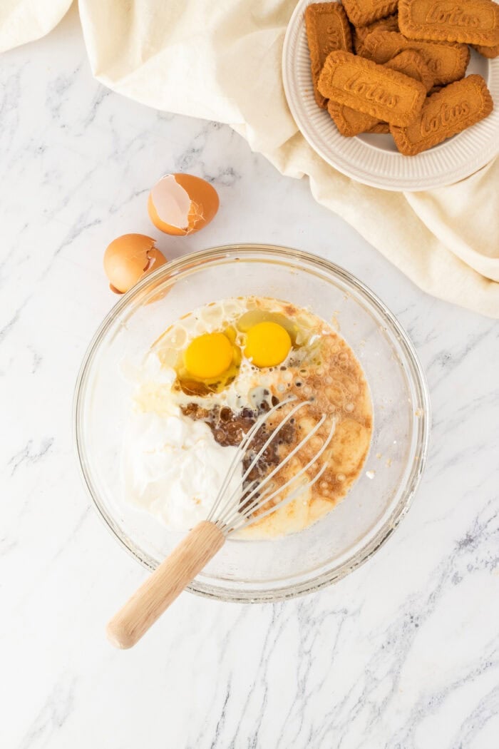 These Biscoff Cupcakes are soft, ultra-moist, and packed with warm caramelized flavor from cookie butter in both the batter and frosting. Eggs and sugar in a bowl