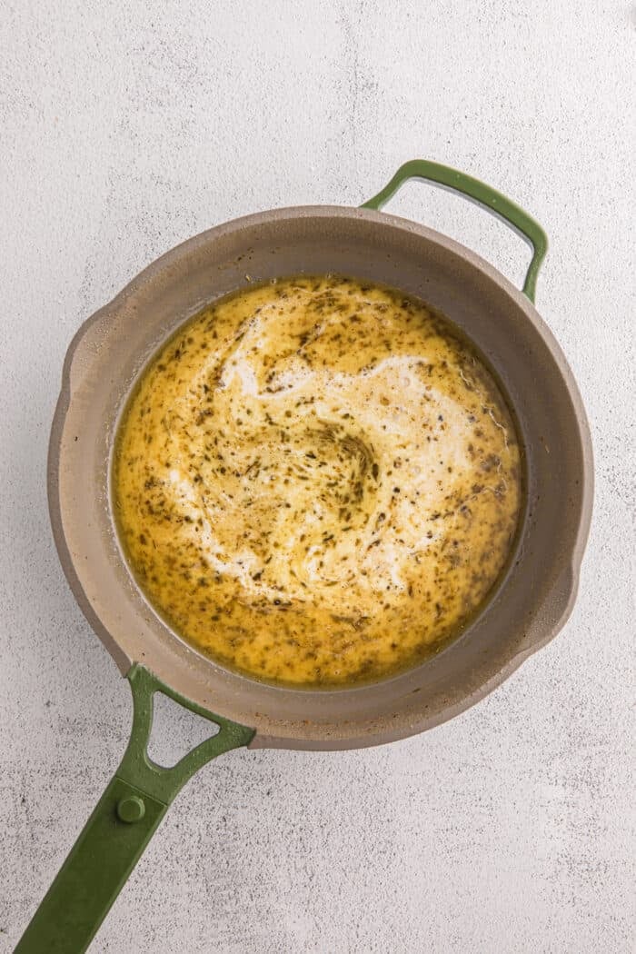 Juicy pan-fried chicken is coated in a creamy, garlicky white wine sauce with spinach and freshly grated parmesan in this Chicken Florentine. Florentine sauce ingredients in a pan