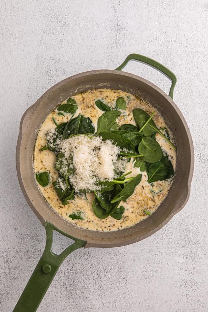 Juicy pan-fried chicken is coated in a creamy, garlicky white wine sauce with spinach and freshly grated parmesan in this Chicken Florentine. Spinach and parmesan cheese stirred in