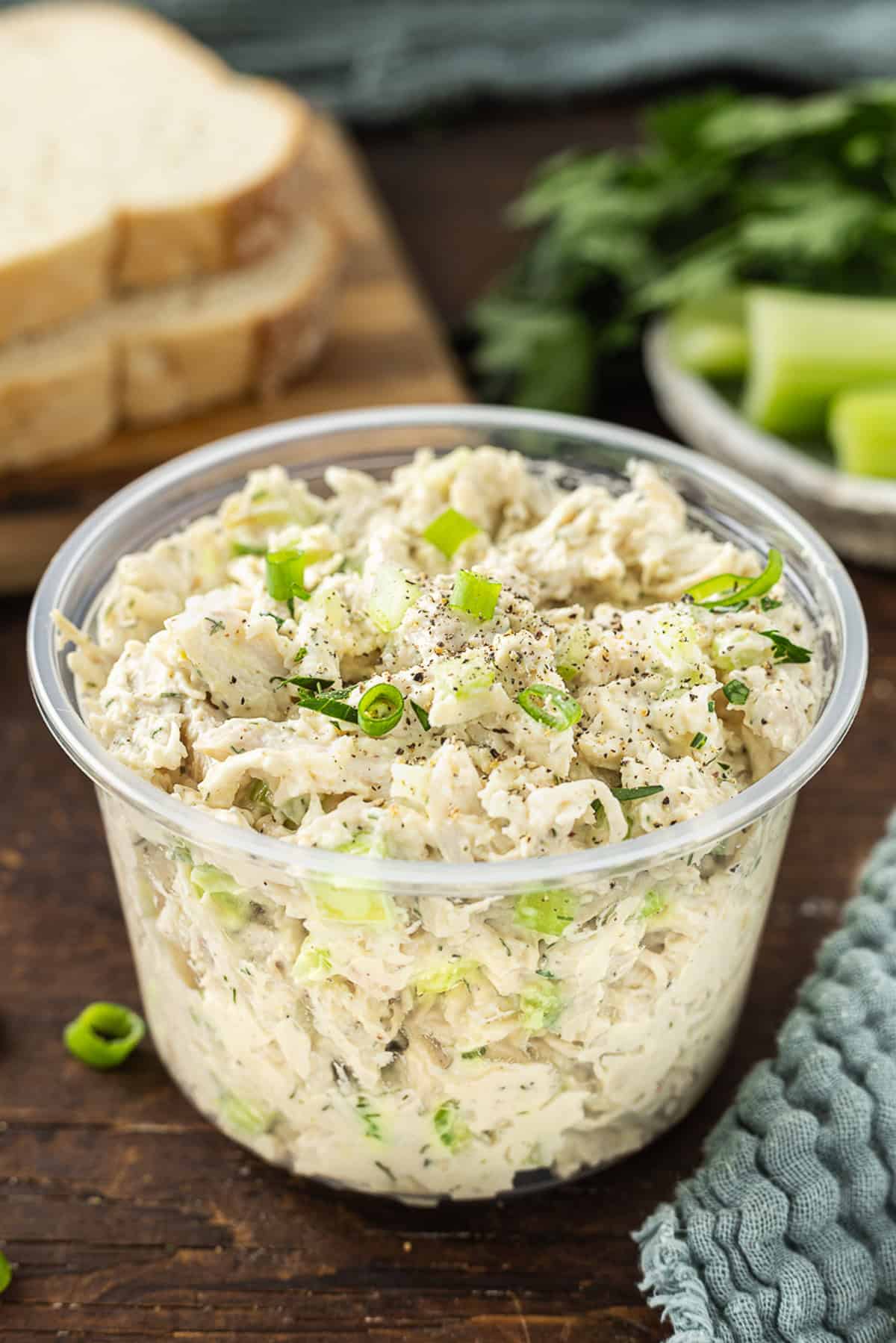 This Classic Chicken Salad Recipe is a simple, no-frills lunch made with shredded chicken, celery, & green onions tossed with mayo and dill. Classic chicken salad in a plastic container