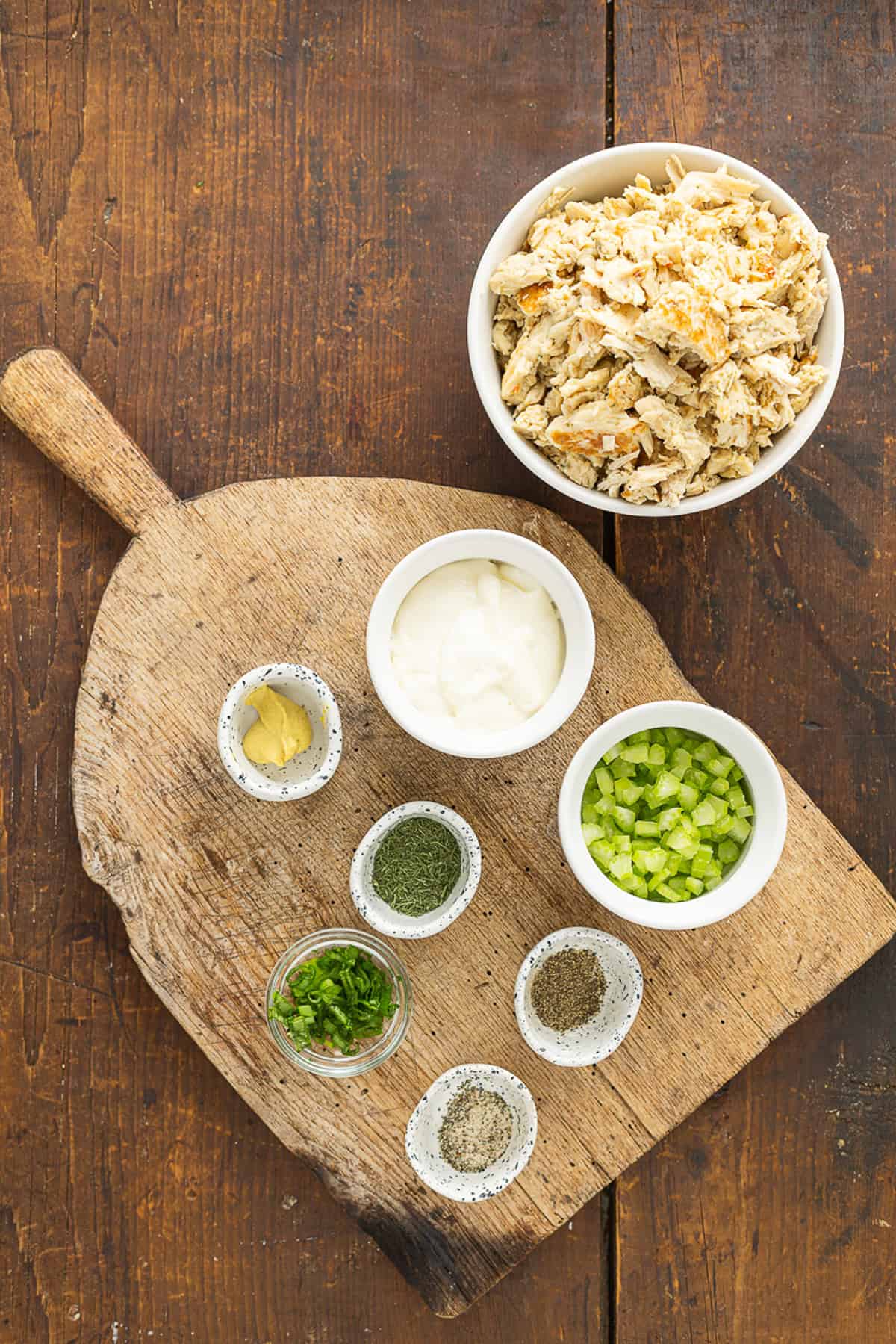 This Classic Chicken Salad Recipe is a simple, no-frills lunch made with shredded chicken, celery, & green onions tossed with mayo and dill. Overhead view of ingredients needed to make classic chicken salad