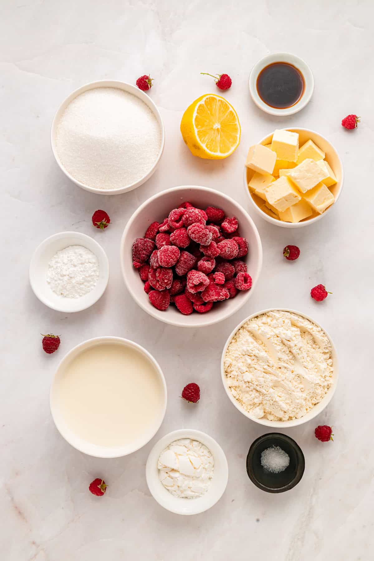 This rustic Raspberry Cobbler recipe is made with a jammy fruit filling and a golden, biscuit-style topping. Quick & easy! Overhead view of ingredients needed to make raspberry cobbler