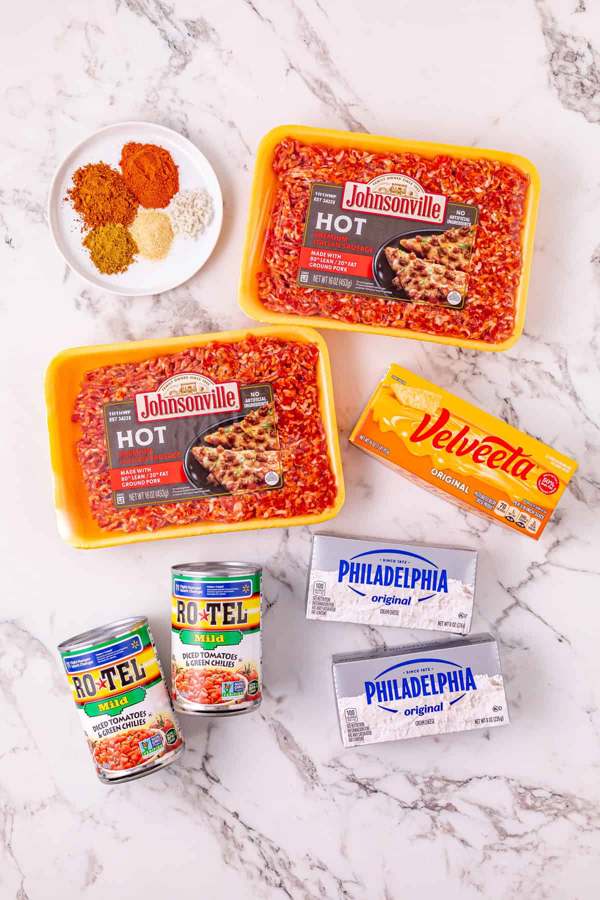 Cheesy Sausage Dip turns ground sausage, Velveeta, cream cheese, and Rotel into a creamy, cheesy, and irresistible party dip in just minutes. Overhead view of ingredients needed to make sausage dip