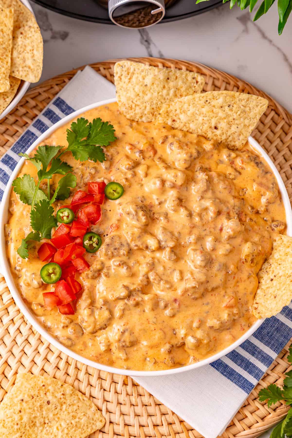 Cheesy Sausage Dip turns ground sausage, Velveeta, cream cheese, and Rotel into a creamy, cheesy, and irresistible party dip in just minutes. Overhead view of a bowl of cheesy sausage dip