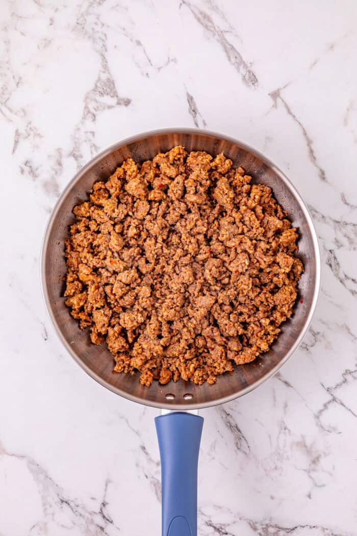 Cheesy Sausage Dip turns ground sausage, Velveeta, cream cheese, and Rotel into a creamy, cheesy, and irresistible party dip in just minutes. Cooked ground sausage in a pan