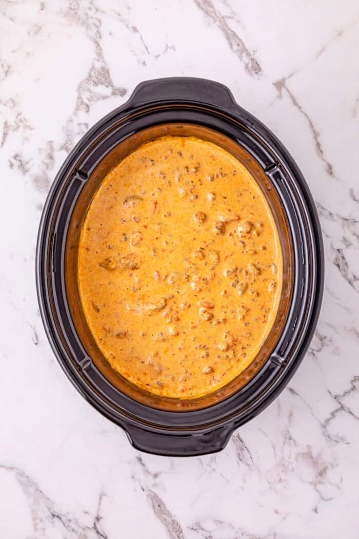 Cheesy Sausage Dip turns ground sausage, Velveeta, cream cheese, and Rotel into a creamy, cheesy, and irresistible party dip in just minutes. Sausage dip in the crockpot