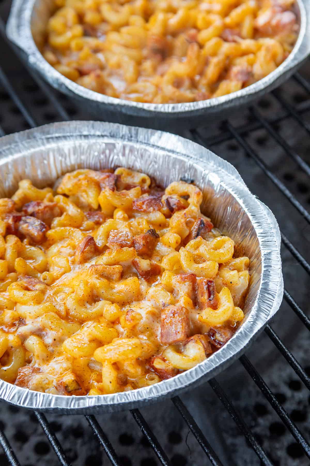 Macaroni and smoked sausage are tossed with a thick, creamy alfredo sauce base and lots of cheese to make this Easy Sausage Mac and Cheese. Overhead view of sausage mac and cheese in foil pans