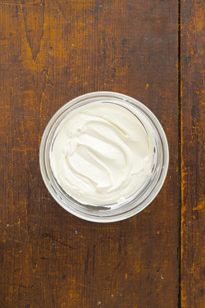 Sweet, savory caramelized onions are combined with tangy sour cream and cream cheese, plus a few seasonings, to make Caramelized Onion Dip. Cream cheese and sour cream in a bowl
