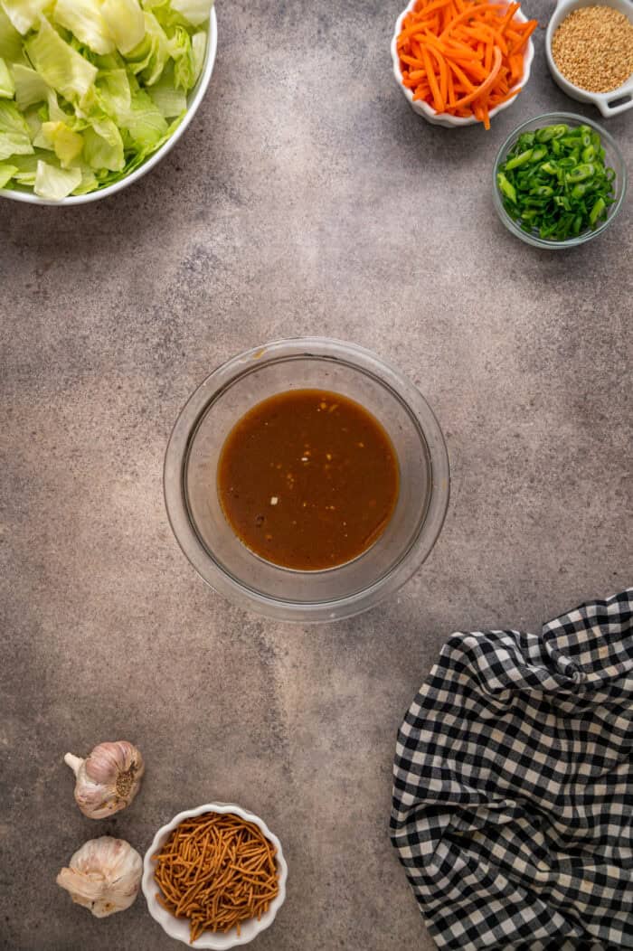 Grilled chicken, crunchy veggies, and mandarin oranges are tossed in a ginger sesame dressing in this easy Chinese Chicken Salad recipe. Ginger dressing in a small bowl