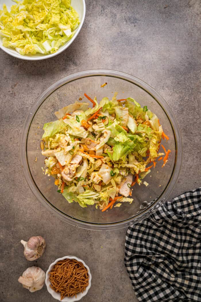 Grilled chicken, crunchy veggies, and mandarin oranges are tossed in a ginger sesame dressing in this easy Chinese Chicken Salad recipe. Overhead view of a bowl of Chinese chicken salad