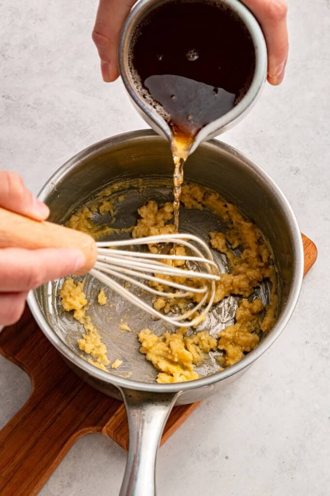 This Beer Cheese Dip is warm, sharp, and just a little smoky, with a combination of cheddar & gruyere and your favorite beer. Pouring beer into a roux