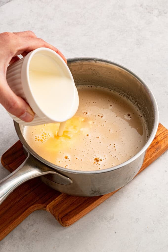 This Beer Cheese Dip is warm, sharp, and just a little smoky, with a combination of cheddar & gruyere and your favorite beer. Adding milk to beer in a pan