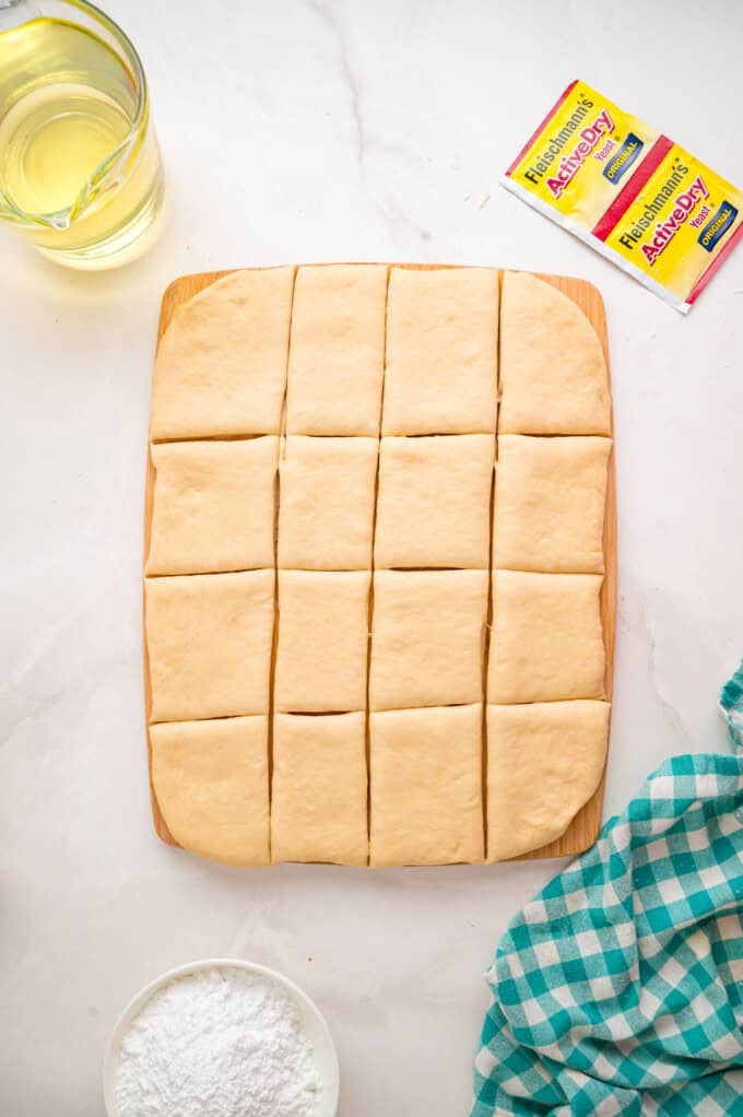This Beignets recipe is an easy homemade version of the popular New Orleans fried square donuts. Soft & fluffy! Dough sliced into squares