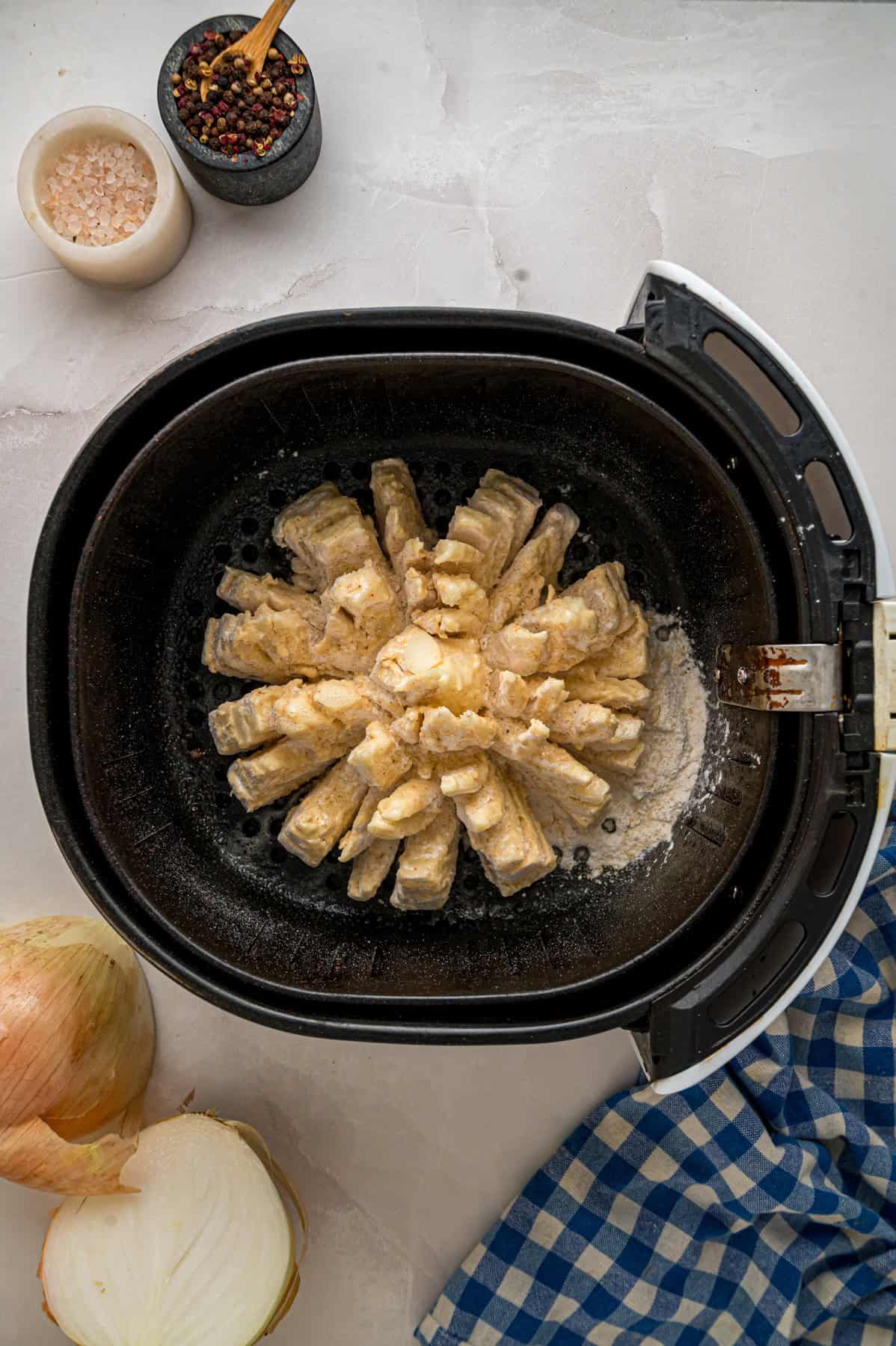Onions are coated in a seasoned batter, then deep-fried to crispy, golden perfection in this Blooming Onion recipe. A blooming onion in the air fryer