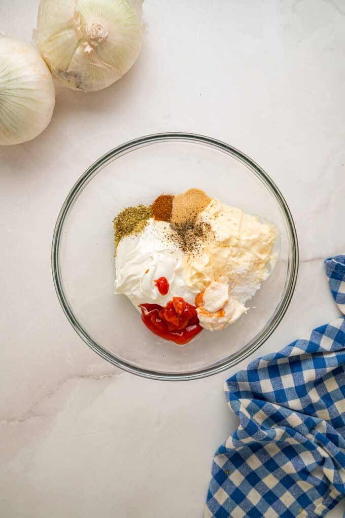 This copycat Outback Steakhouse Blooming Onion Sauce is creamy, tangy, and spicy, and ready in just 5 minutes. Mayo, sour cream, ketchup, horseradish, and spices in a bowl
