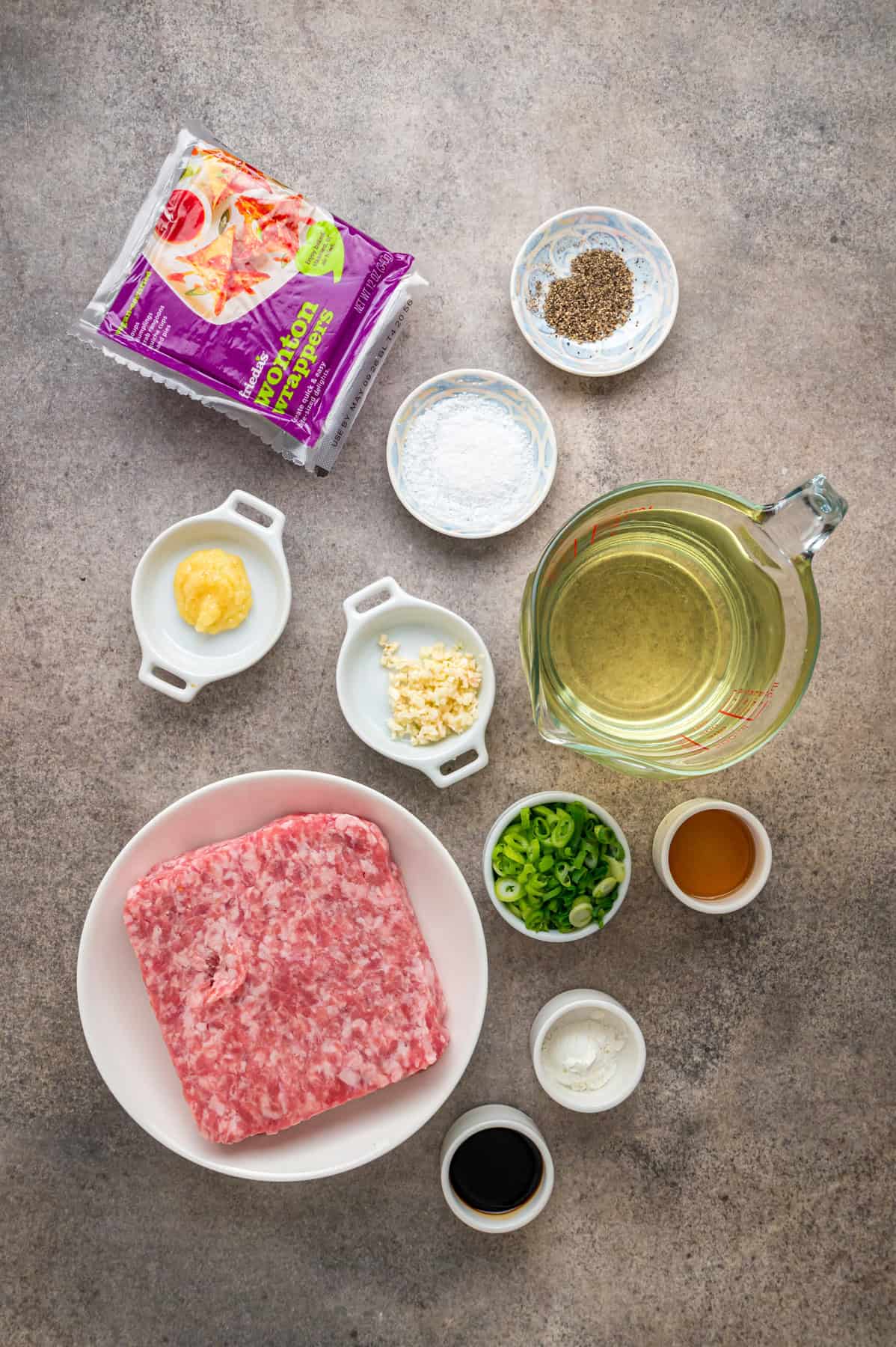 With a savory ground pork filling and crispy golden outside, this Fried Wonton recipe brings Chinese takeout to the table in 30 minutes. Overhead view of ingredients needed to make fried wontons