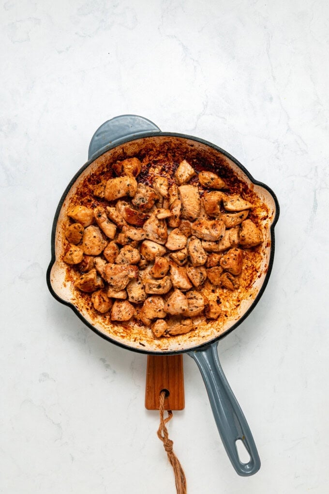 With tender, juicy chicken coated in a creamy garlic sauce, this Garlic Parmesan Chicken Pasta is an easy weeknight dinner. Bite-sized pieces of seasoned chicken in a pan