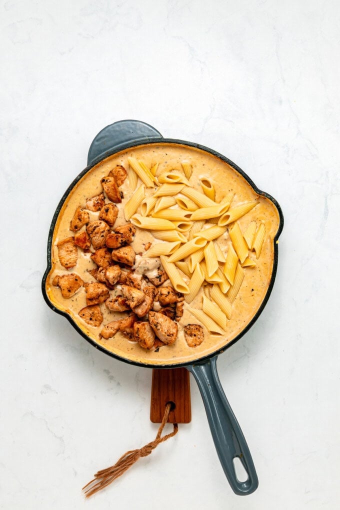With tender, juicy chicken coated in a creamy garlic sauce, this Garlic Parmesan Chicken Pasta is an easy weeknight dinner. Chicken and pasta added to garlic parmesan sauce n a pan
