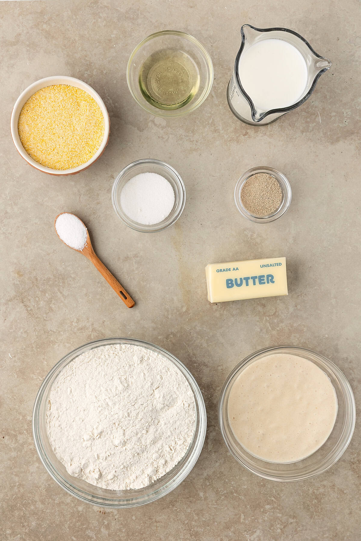 These Sourdough English Muffins are soft, chewy, and full of the classic nooks and crannies everyone loves. Overhead view of ingredients needed to make sourdough English muffins