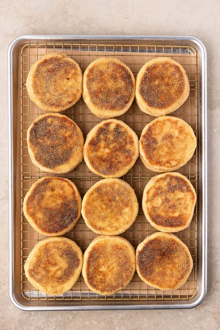 These Sourdough English Muffins are soft, chewy, and full of the classic nooks and crannies everyone loves. Sourdough English muffins on a baking sheet
