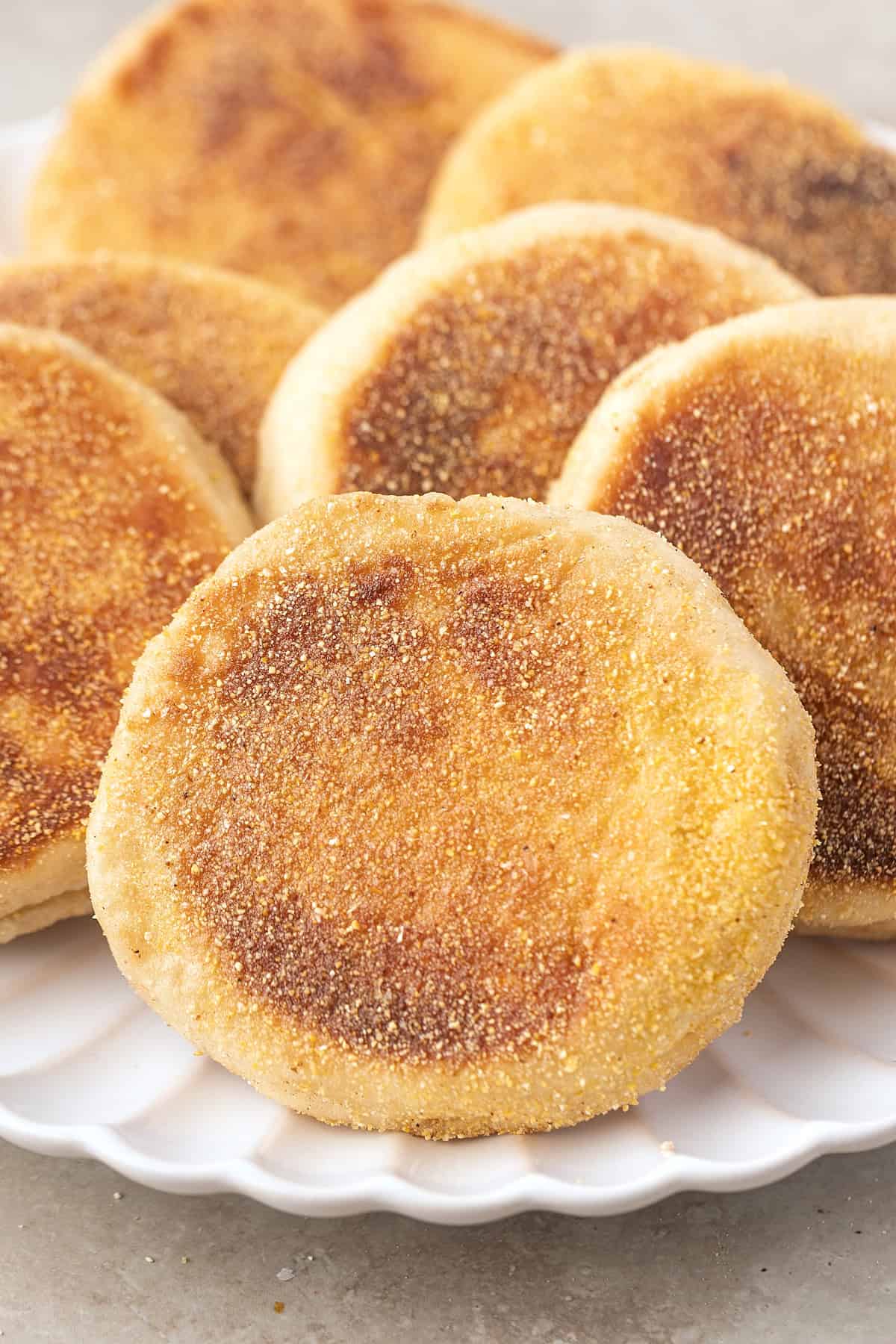 These Sourdough English Muffins are soft, chewy, and full of the classic nooks and crannies everyone loves. A plate of sourdough English muffins