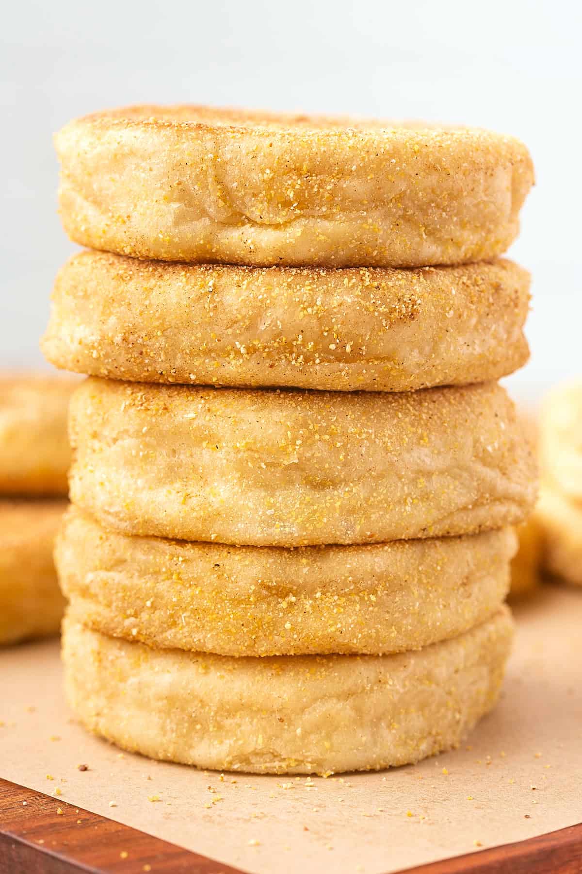 These Sourdough English Muffins are soft, chewy, and full of the classic nooks and crannies everyone loves. Five sourdough English muffins stacked on each other