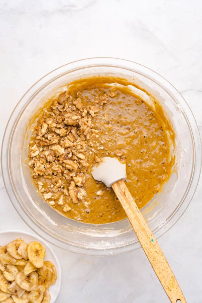 This copycat Starbucks Banana Bread is soft and moist, with lots of sweet banana flavor and warm spices. One bowl + 15 minutes! Folding walnuts into banana bread batter